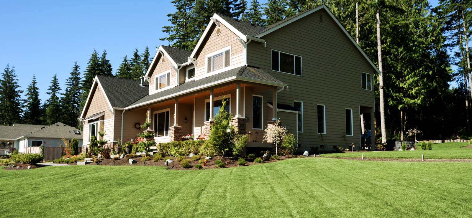 A picture of a nice house with a freshly mowed lawn